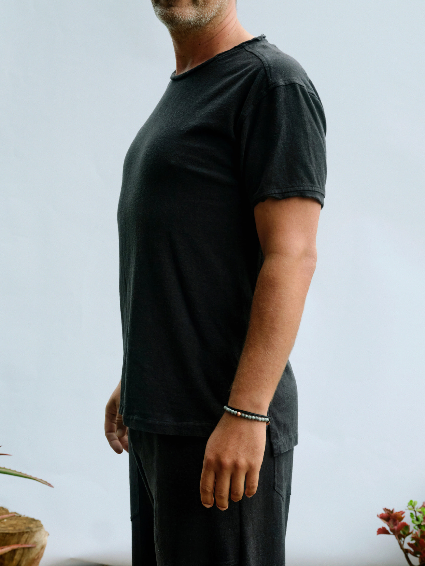 Man wearing the masculine Truth-T short sleeve T-shirt, side profile showing the relaxed cut
