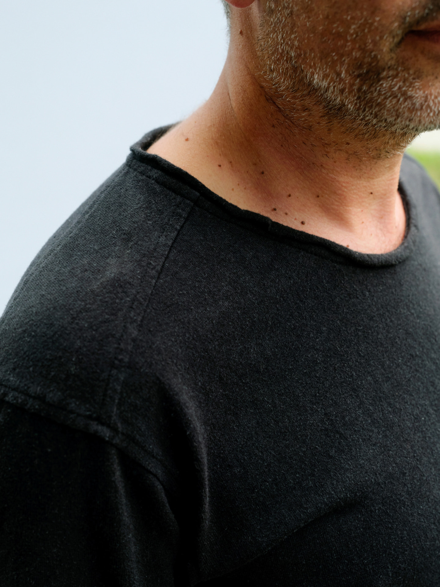 Close view of the masculine Truth-T neckline and shoulder with visible top-stitching