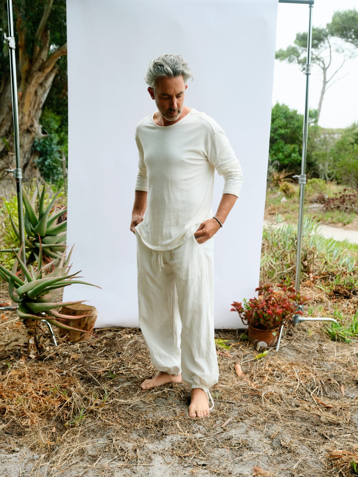 Man wearing the masculine long sleeve David in cream, full length view outdoors