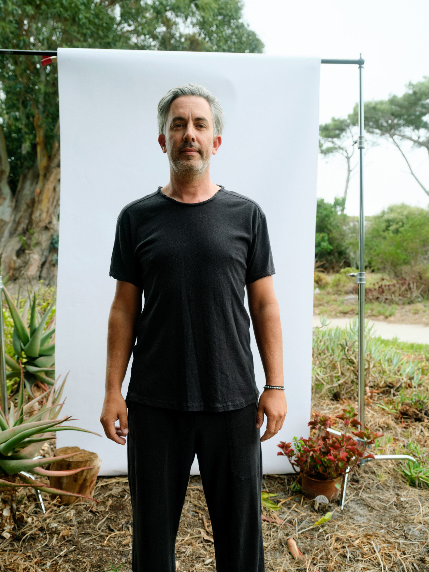 Man wearing the masculine Truth-T short sleeve T-shirt in charcoal, front view against a white backdrop