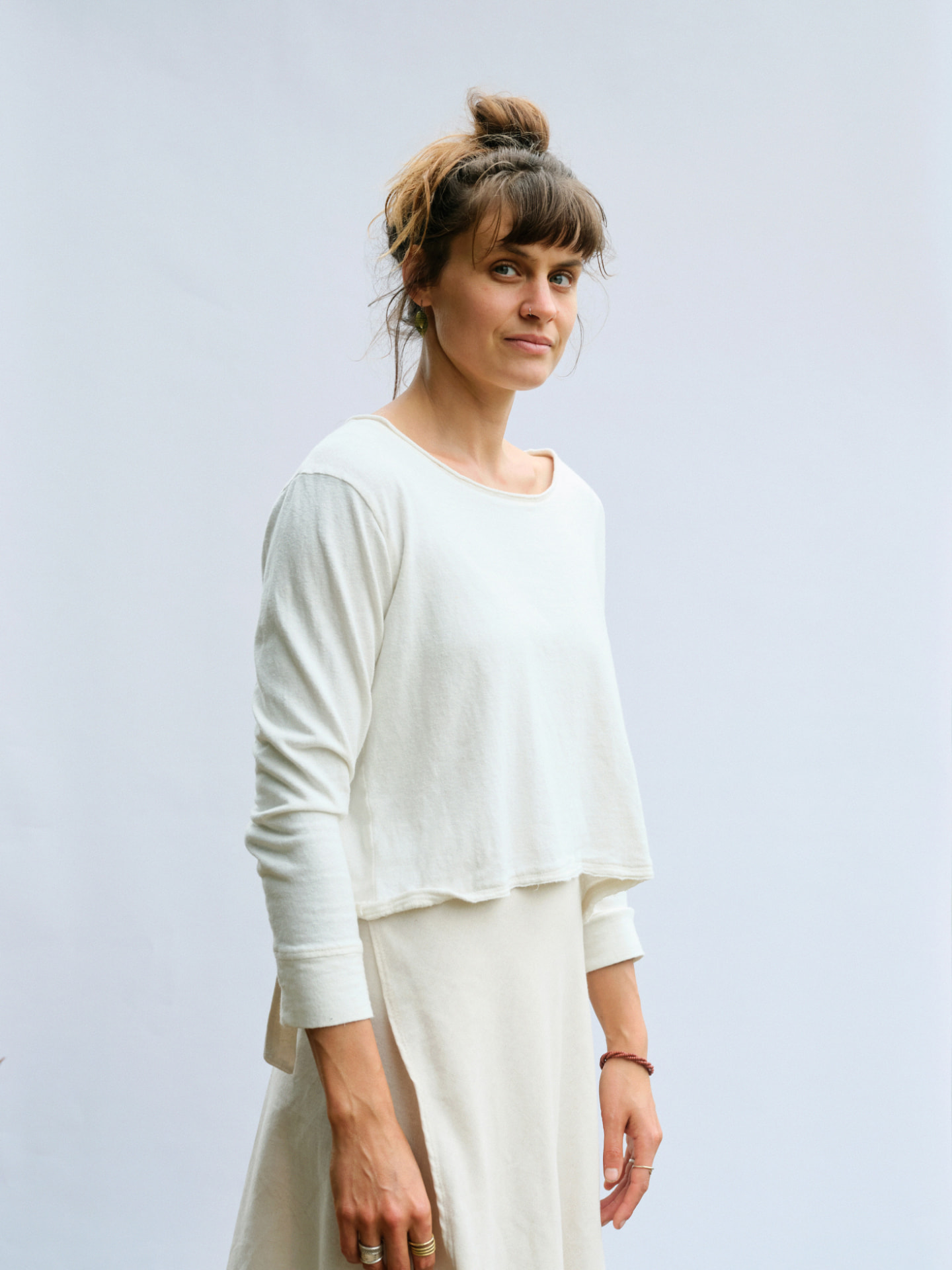 Woman wearing the Bonnie-love long sleeve T-shirt in cream, side profile