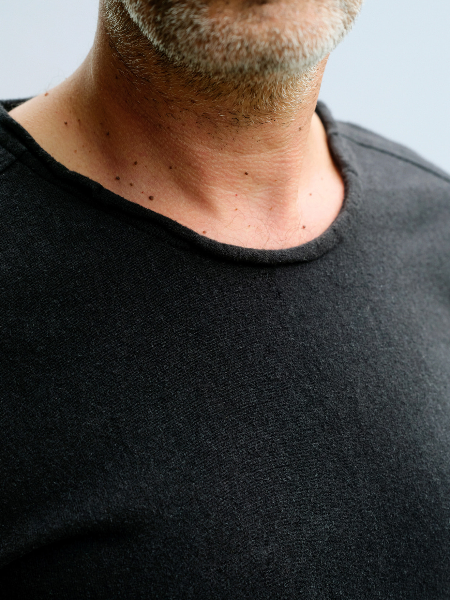 Close view of the masculine Truth-T raw-finish neckline at the front