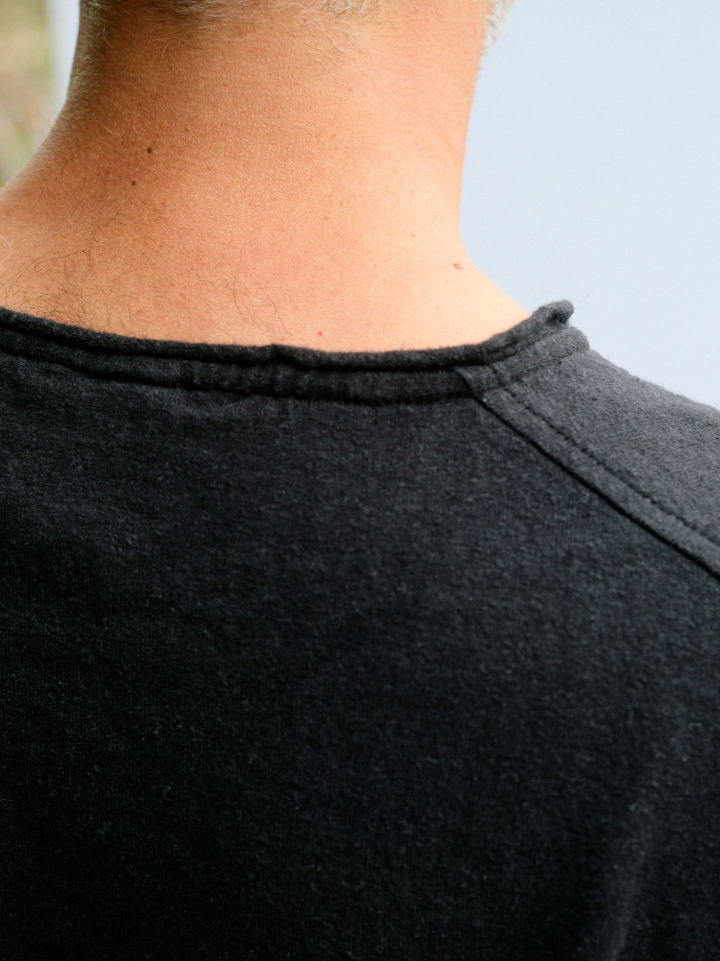Close view of the masculine Truth-T back neckline binding and top-stitching
